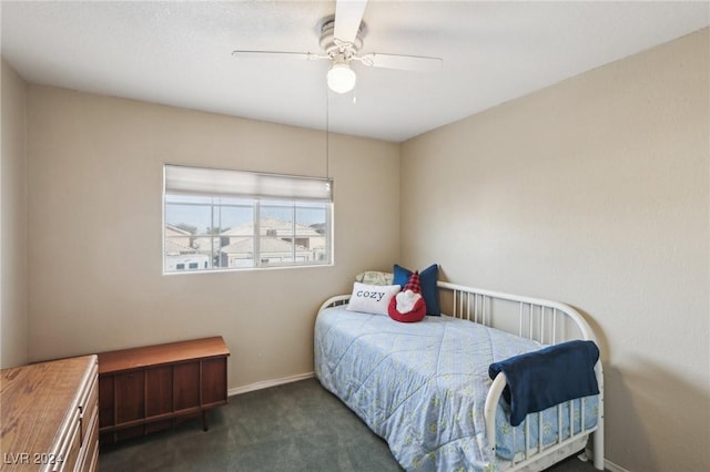 bedroom with ceiling fan and dark carpet