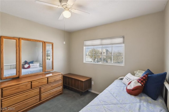 bedroom featuring dark carpet and ceiling fan