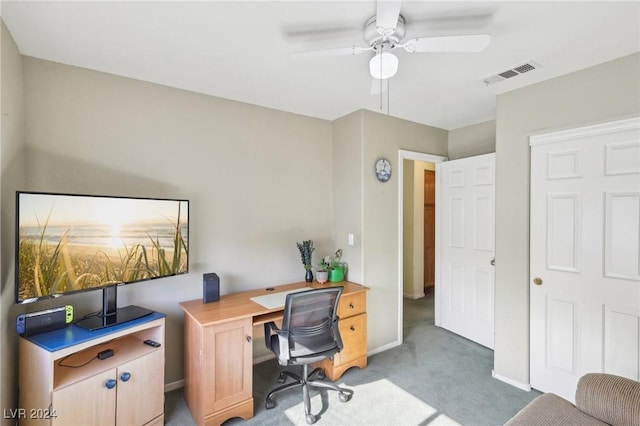 office space featuring light carpet and ceiling fan