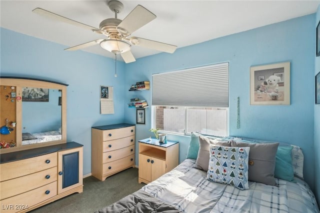 bedroom featuring ceiling fan and dark colored carpet