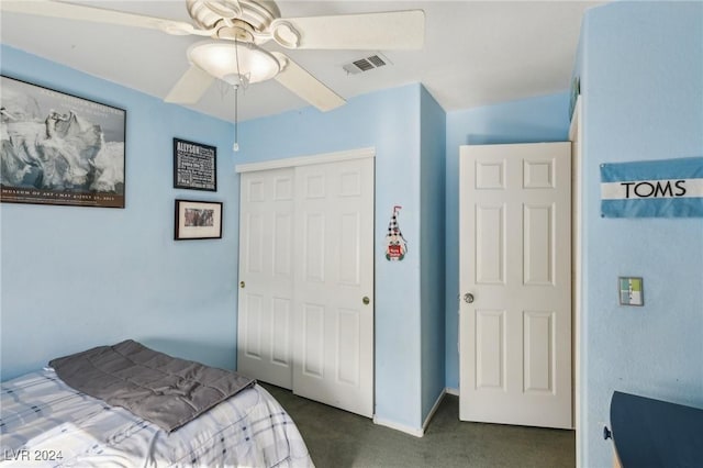 bedroom featuring dark carpet, a closet, and ceiling fan