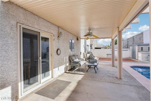 view of patio with a storage shed and ceiling fan