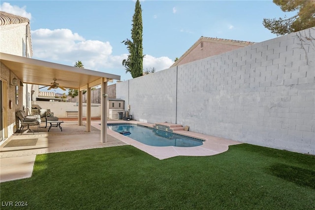 view of pool featuring a lawn, ceiling fan, and a patio area