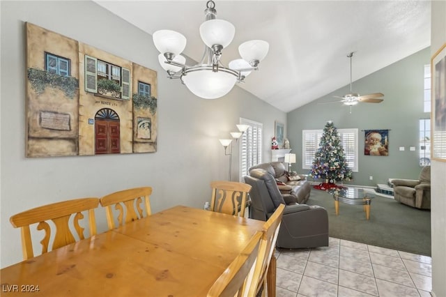 tiled dining area with ceiling fan with notable chandelier and high vaulted ceiling