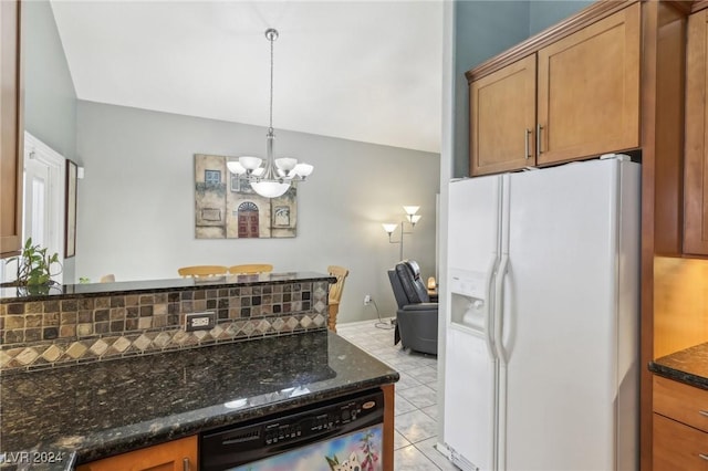 kitchen featuring dark stone countertops, hanging light fixtures, white fridge with ice dispenser, decorative backsplash, and stainless steel dishwasher