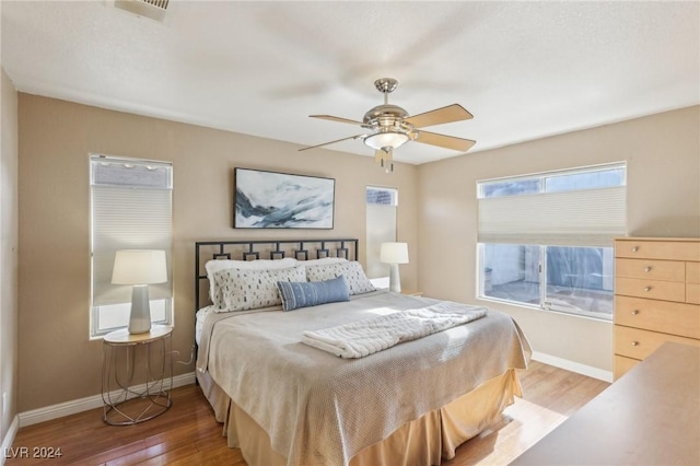 bedroom with hardwood / wood-style flooring and ceiling fan