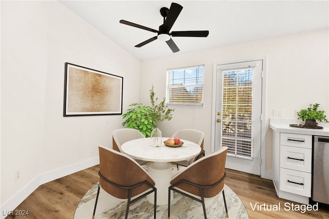 dining room with ceiling fan, lofted ceiling, and light wood-type flooring