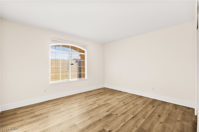 unfurnished room with light wood-type flooring