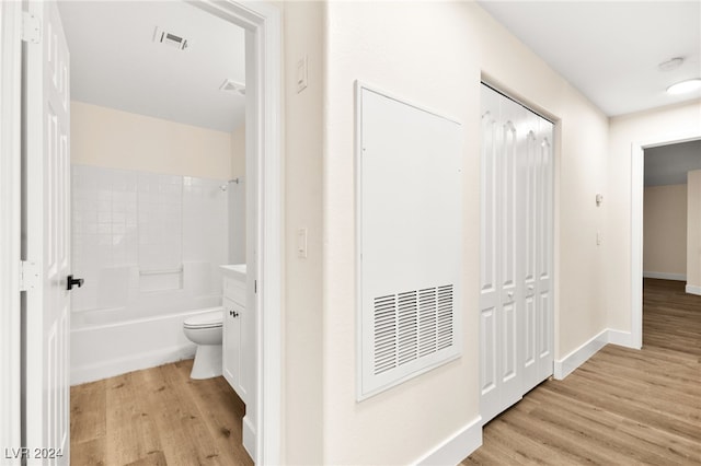 hallway with light hardwood / wood-style flooring