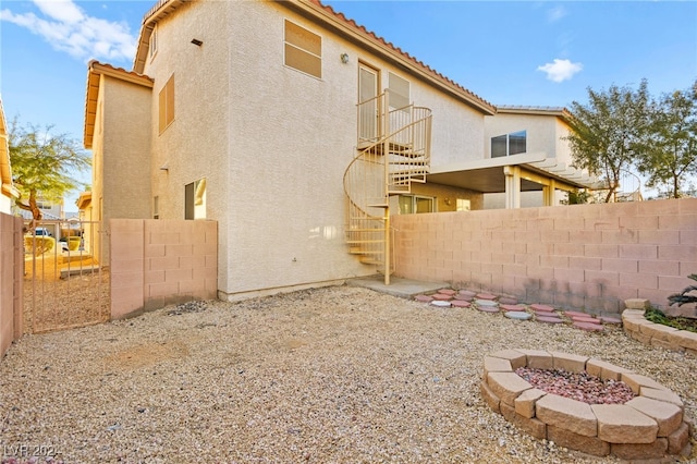 back of property featuring an outdoor fire pit