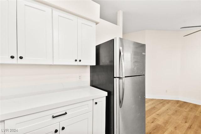 kitchen with white cabinetry, stainless steel fridge, light hardwood / wood-style flooring, and ceiling fan