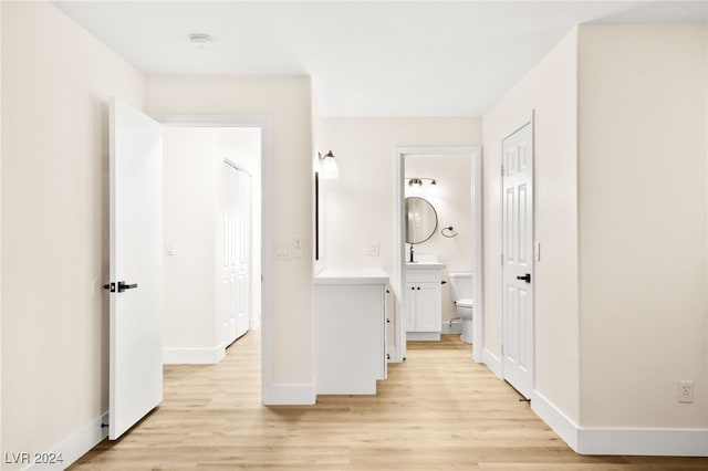 corridor featuring light hardwood / wood-style floors and sink