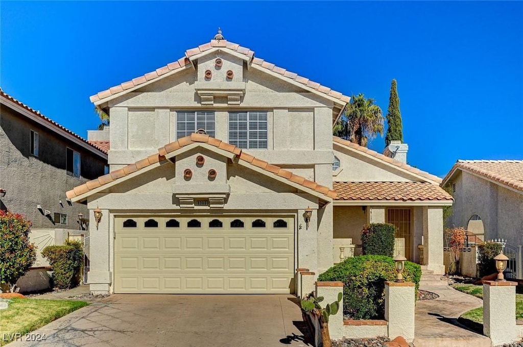 mediterranean / spanish house featuring a garage