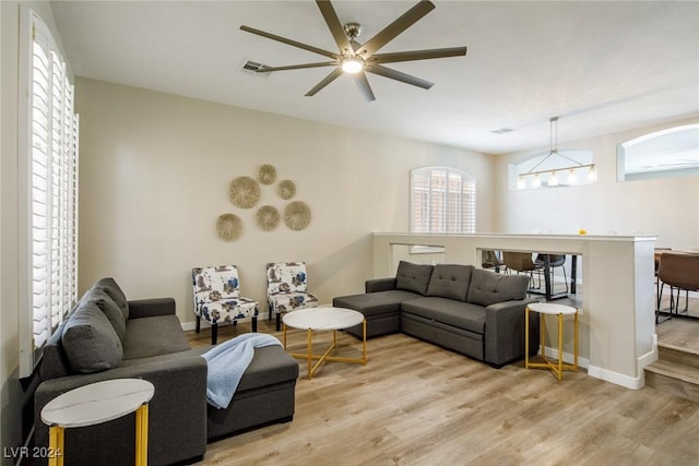 living room featuring light hardwood / wood-style floors and ceiling fan