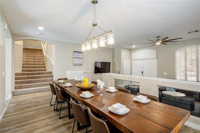 dining room with ceiling fan and light hardwood / wood-style flooring