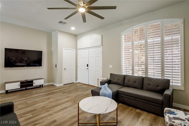 living room with ceiling fan and light wood-type flooring