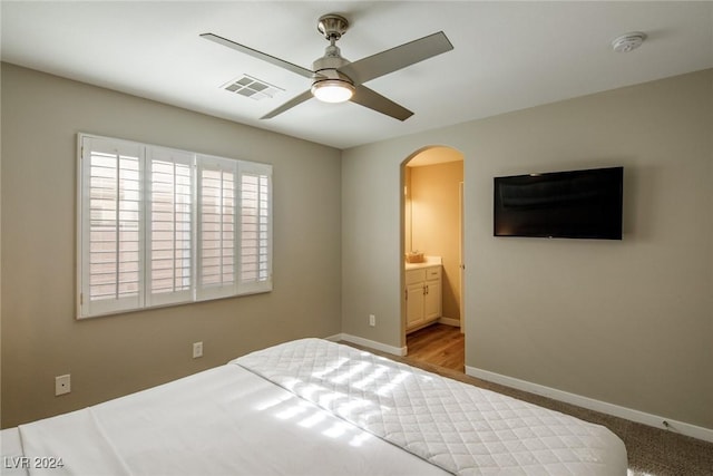 carpeted bedroom featuring connected bathroom and ceiling fan