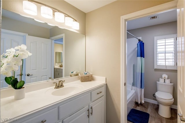 full bathroom featuring vanity, toilet, wood-type flooring, and shower / tub combo with curtain