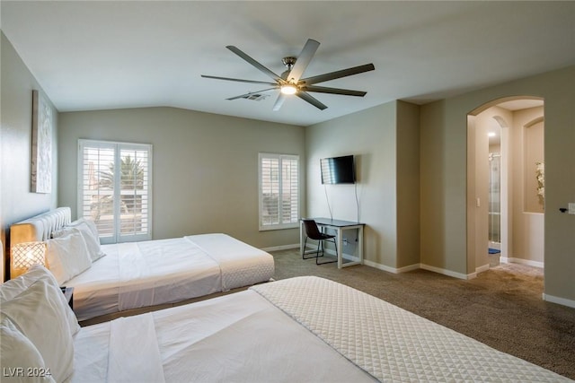 carpeted bedroom with ceiling fan and vaulted ceiling