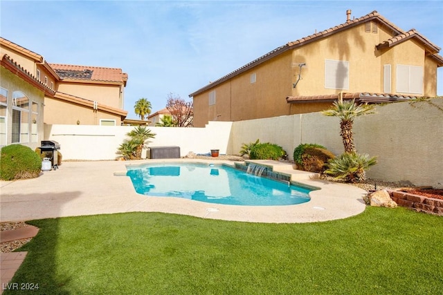 view of pool featuring pool water feature, a yard, a patio, and central AC unit