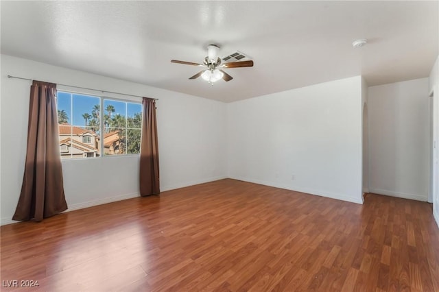 spare room with hardwood / wood-style floors and ceiling fan