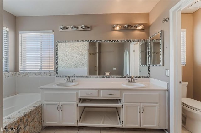 bathroom featuring tile patterned floors, vanity, and toilet