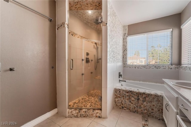 bathroom with vanity, tile patterned flooring, and plus walk in shower