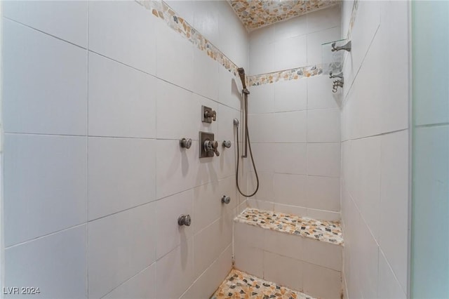 bathroom with tiled shower