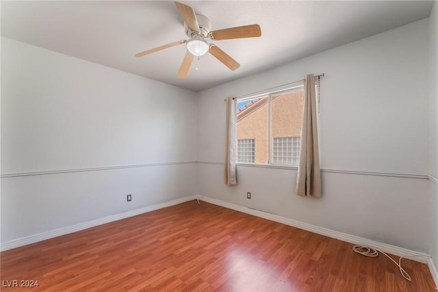 unfurnished room with hardwood / wood-style flooring and ceiling fan