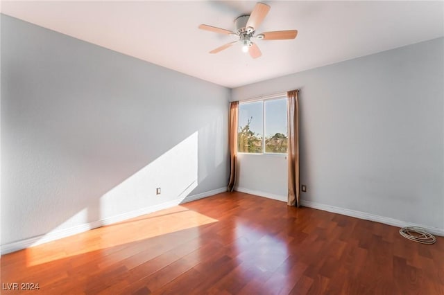 unfurnished room featuring ceiling fan and dark hardwood / wood-style floors