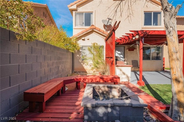 exterior space featuring a pergola, a patio area, and an outdoor fire pit