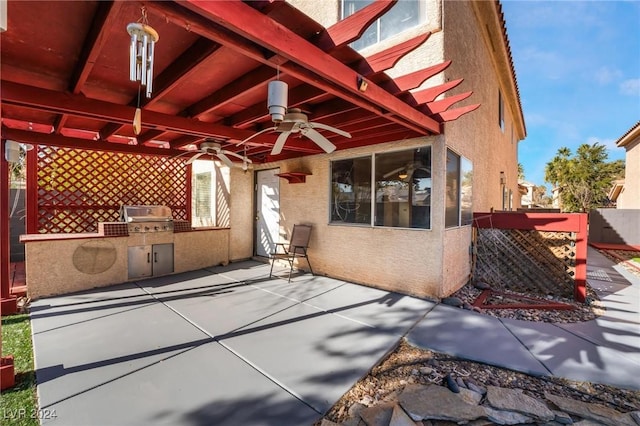 view of patio with area for grilling, ceiling fan, and an outdoor kitchen