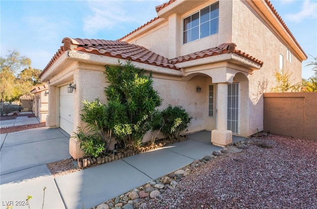 mediterranean / spanish-style home with a garage