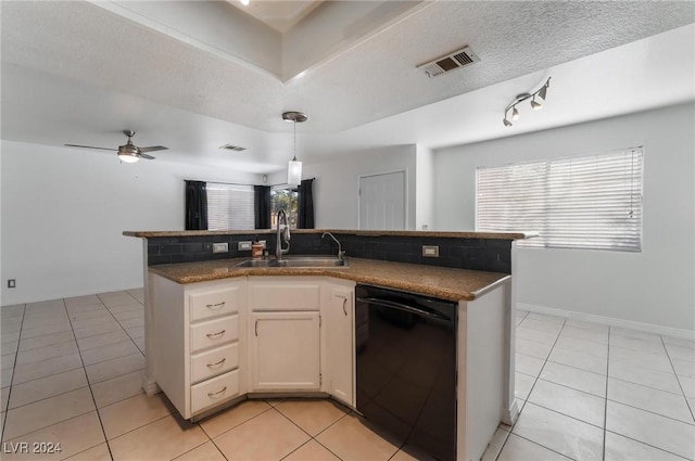 kitchen with dishwasher, sink, light tile patterned floors, a textured ceiling, and white cabinetry