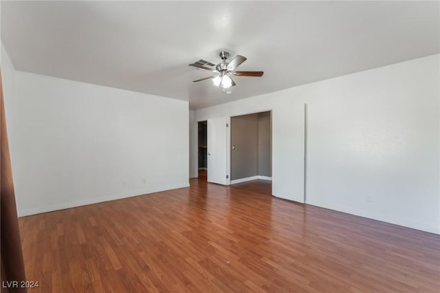 empty room with ceiling fan and hardwood / wood-style floors