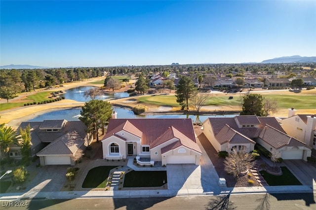 aerial view with a residential view, a water view, and golf course view