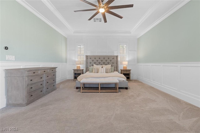 carpeted bedroom featuring ceiling fan, a raised ceiling, and ornamental molding