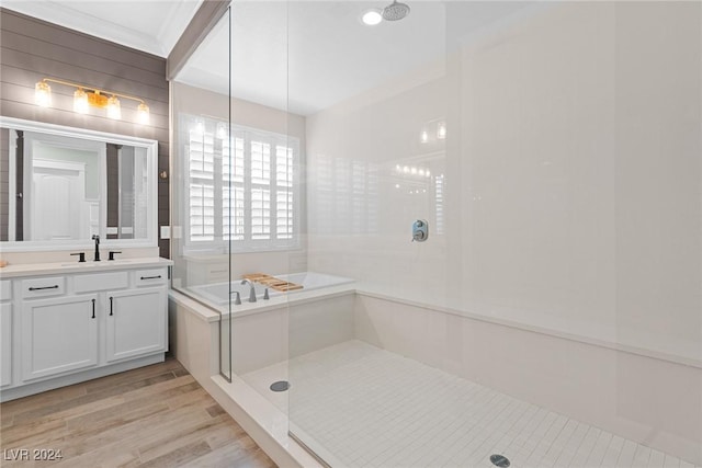 bathroom featuring hardwood / wood-style floors, vanity, and plus walk in shower