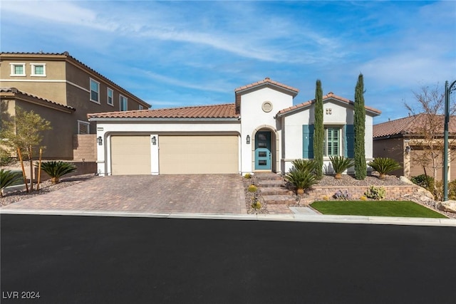 mediterranean / spanish house featuring a garage