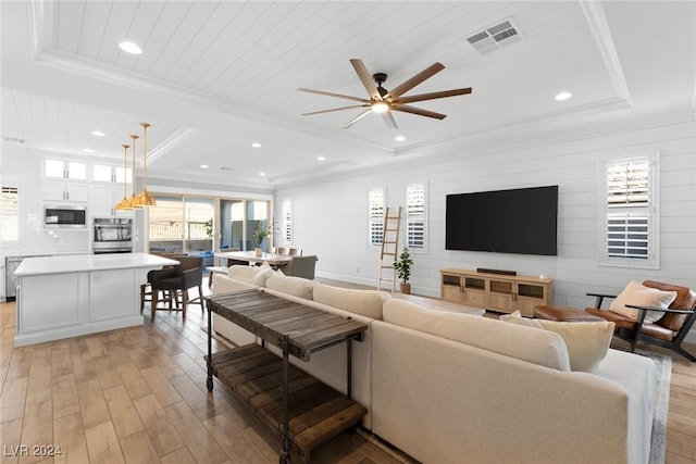 living room featuring a tray ceiling, ceiling fan, wood ceiling, and light wood-type flooring