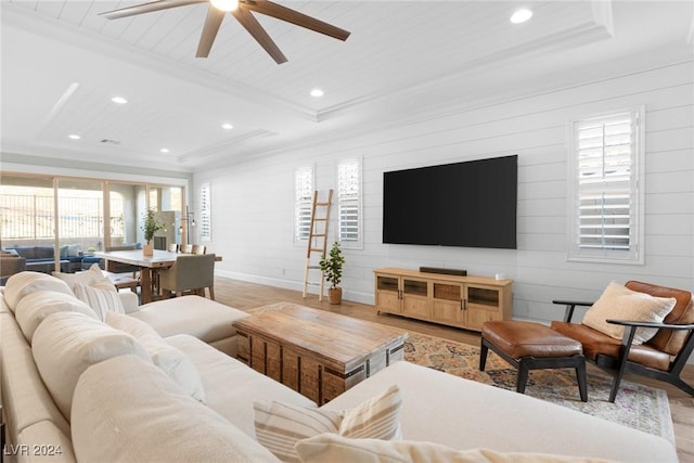 living room featuring ceiling fan, light hardwood / wood-style flooring, beamed ceiling, and wood walls