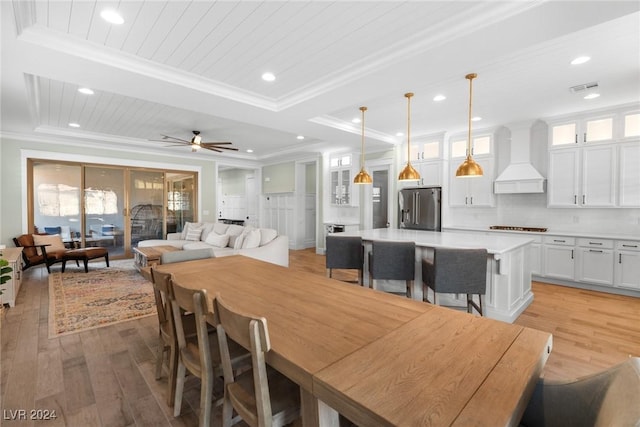 dining room with light wood-type flooring, wooden ceiling, ceiling fan, and crown molding