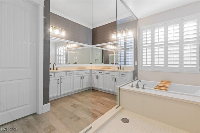 bathroom featuring hardwood / wood-style floors, vanity, decorative backsplash, a washtub, and ornamental molding