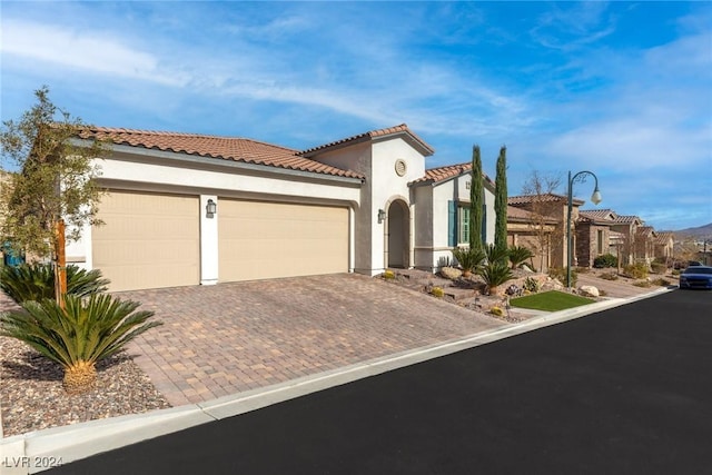 mediterranean / spanish home featuring a garage