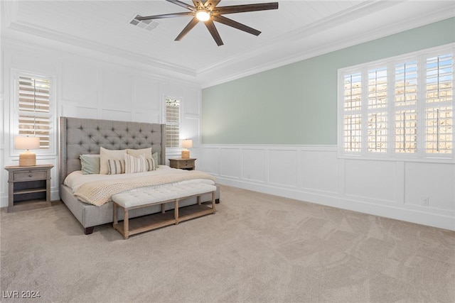 bedroom featuring ceiling fan, ornamental molding, and light carpet