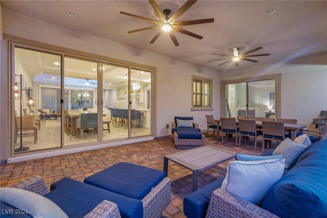 living room featuring ceiling fan and a textured ceiling