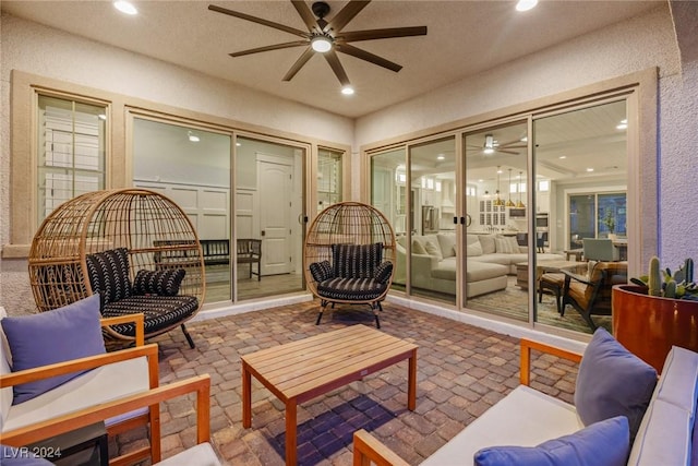 interior space featuring outdoor lounge area and ceiling fan