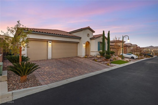 mediterranean / spanish house featuring a garage