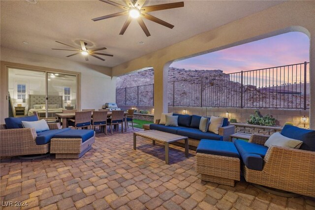 patio terrace at dusk featuring outdoor lounge area