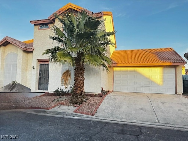 mediterranean / spanish-style house featuring a garage